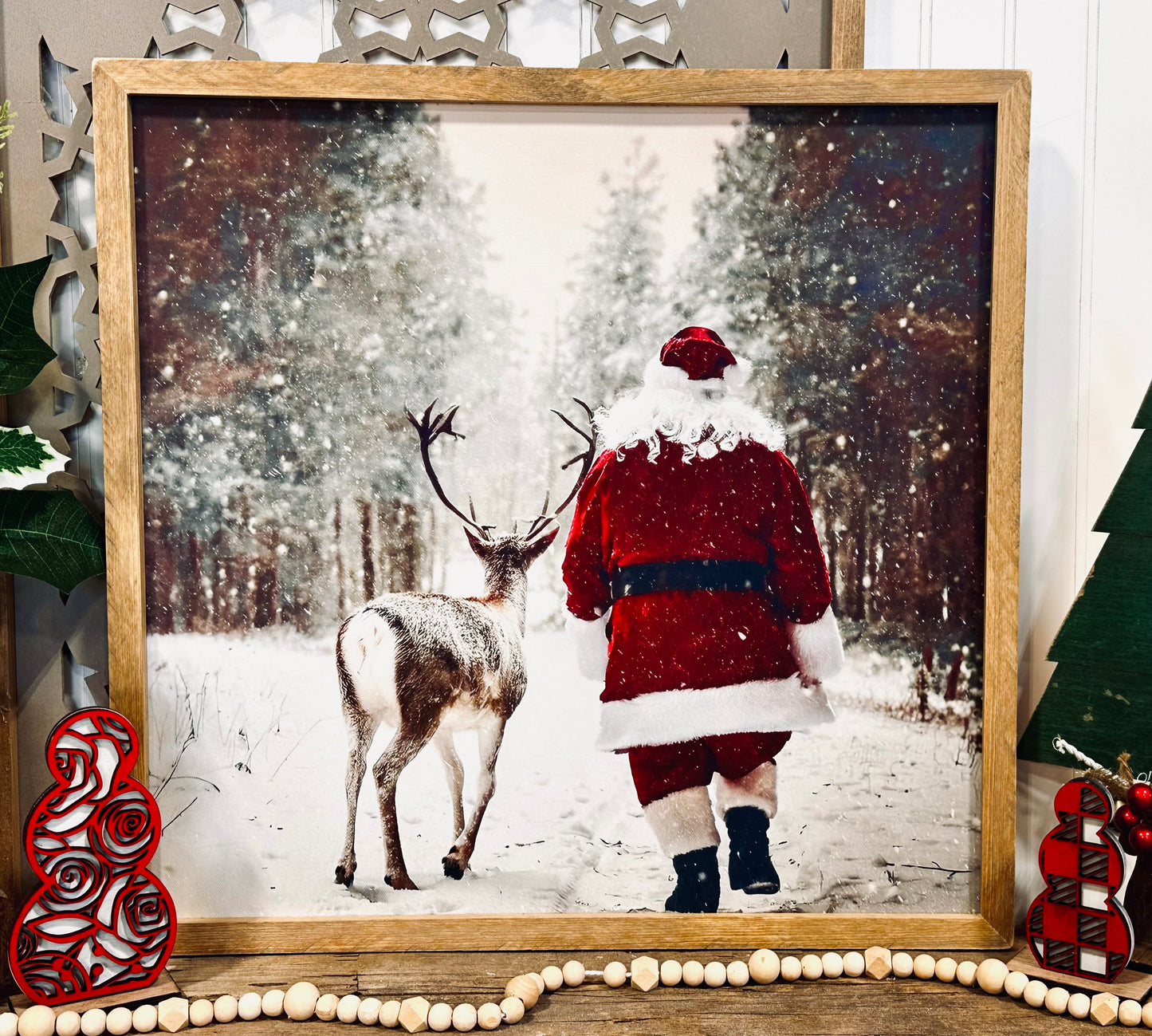 Santa walking with reindeer wood framed canvas print