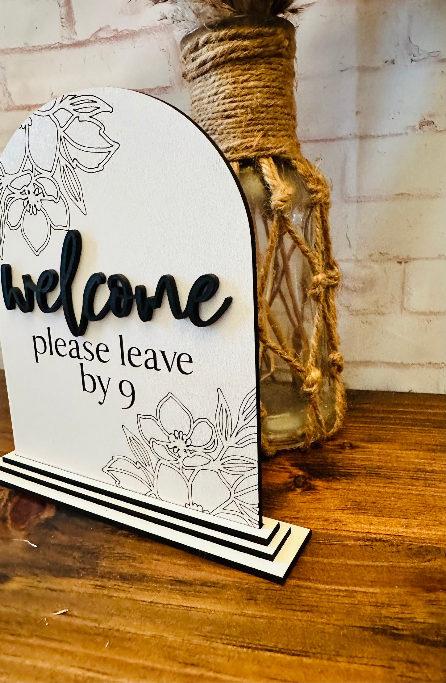 Welcome please leave by nine sign