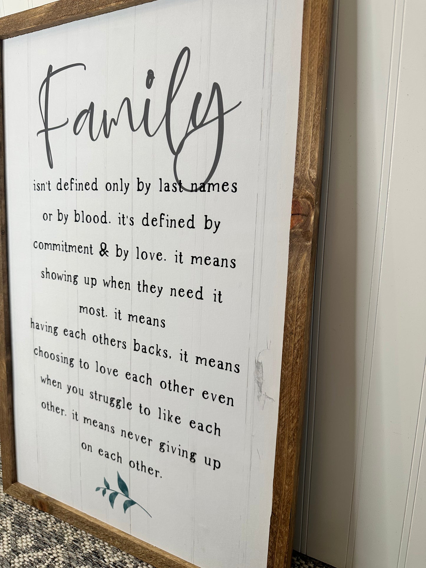 Family isn’t defined only by last name or by blood farmhouse wood sign